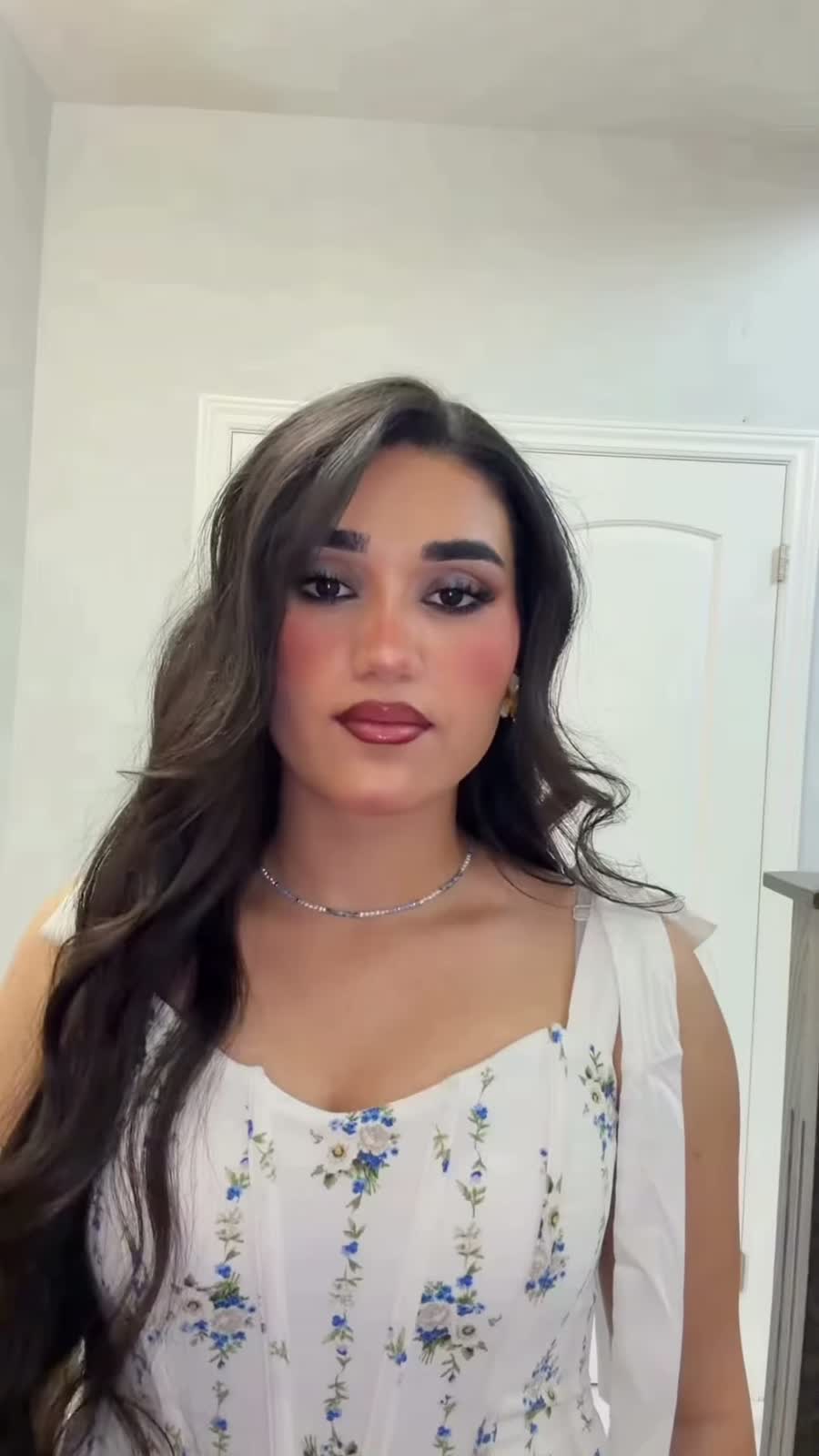 Kocer after her transformation: smoky eyes, berry lips, waves and a floral dress