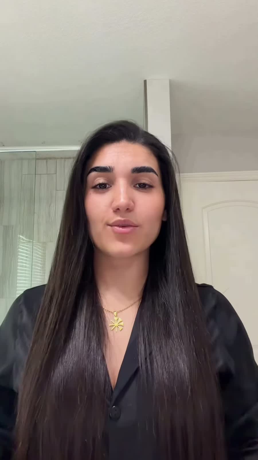 Kocer before her transformation: straight hair and a black shirt
