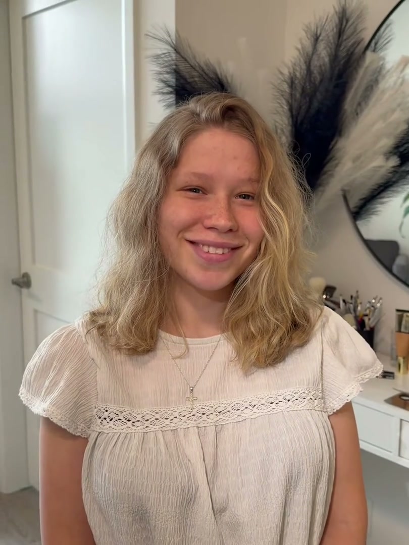 Client three before makeup: a bare face, smiling at the camera